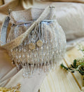 Meher hand-beaded potli in champagne with crystal drop fringe and detachable beaded strap