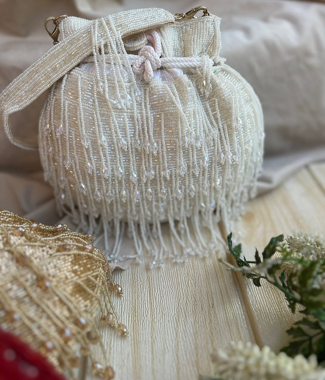 Meher hand-beaded potli in ivory with pearl-white crystal fringe