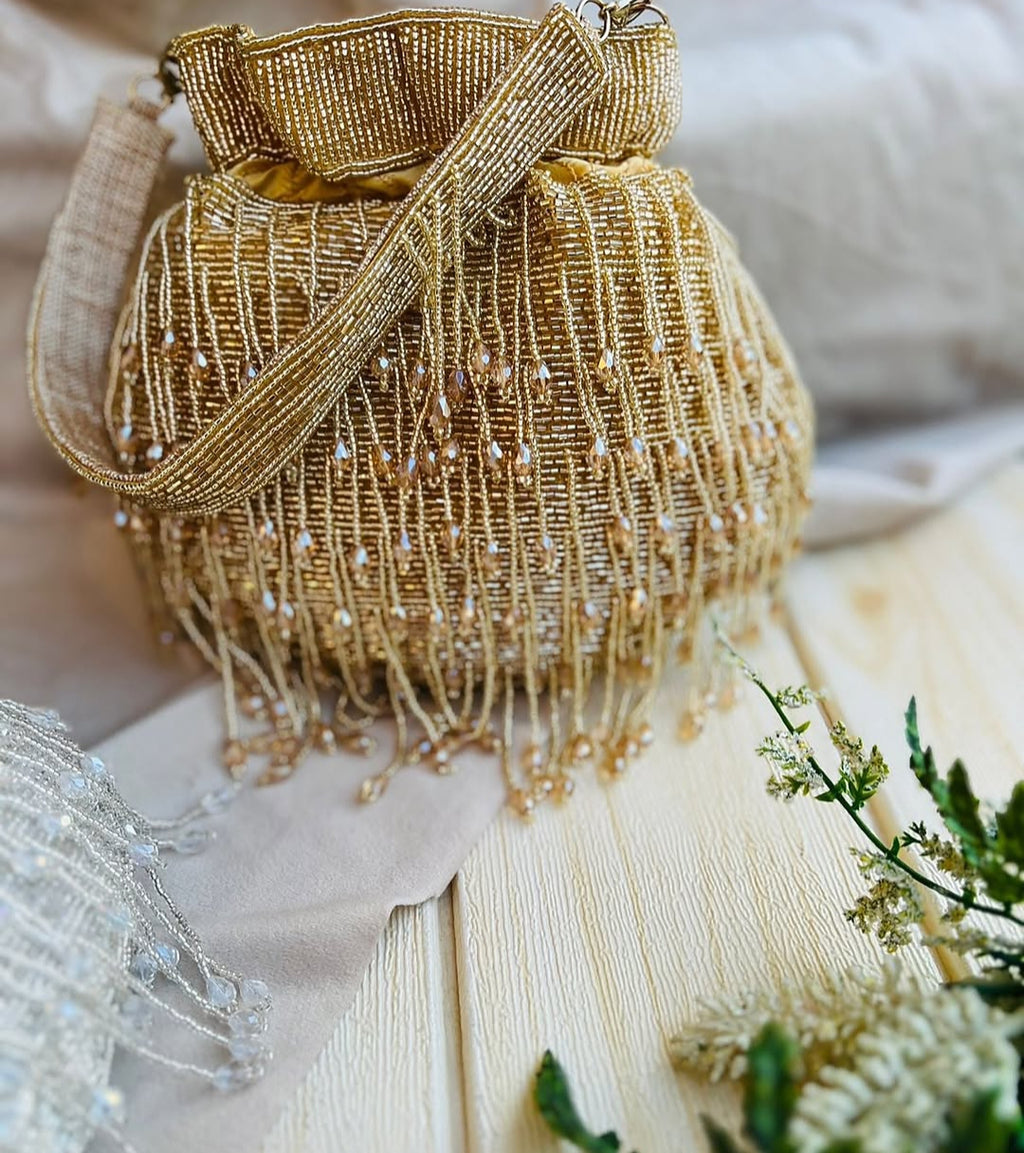 Meher hand-beaded potli in gold with crystal drop fringe