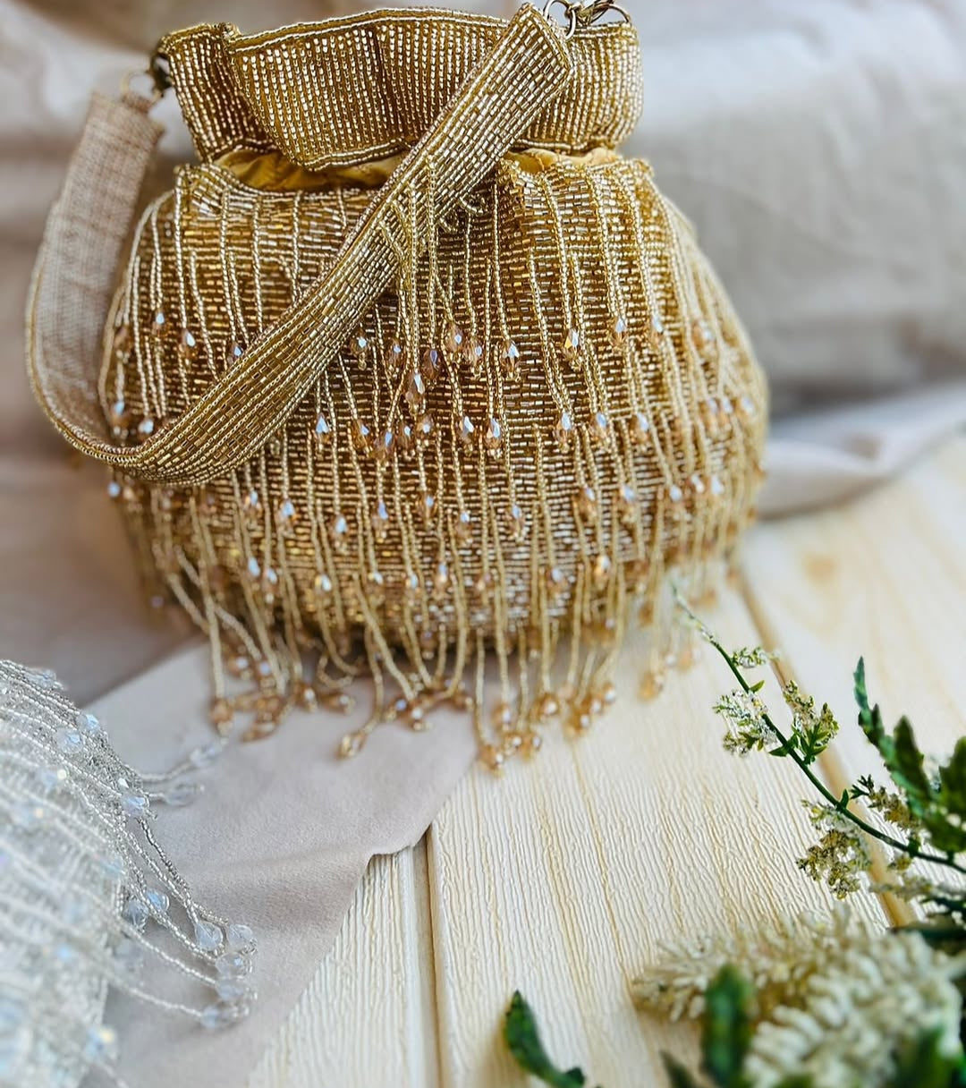 Meher hand-beaded potli in gold with crystal drop fringe