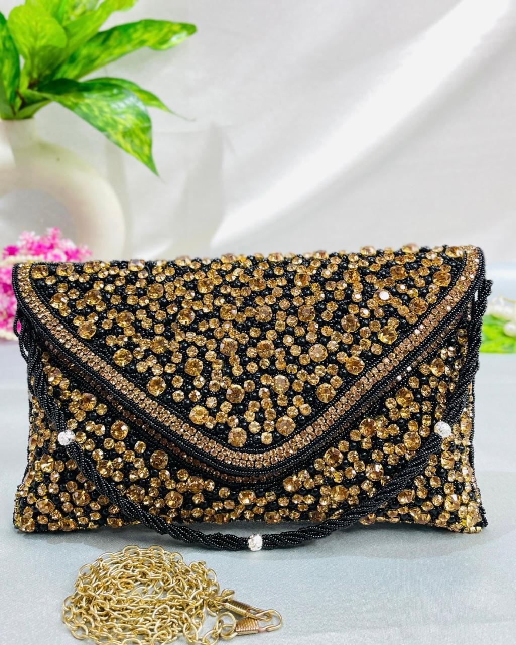 Sitara envelope clutch in black and gold with hand-set crystals and detachable gold chain