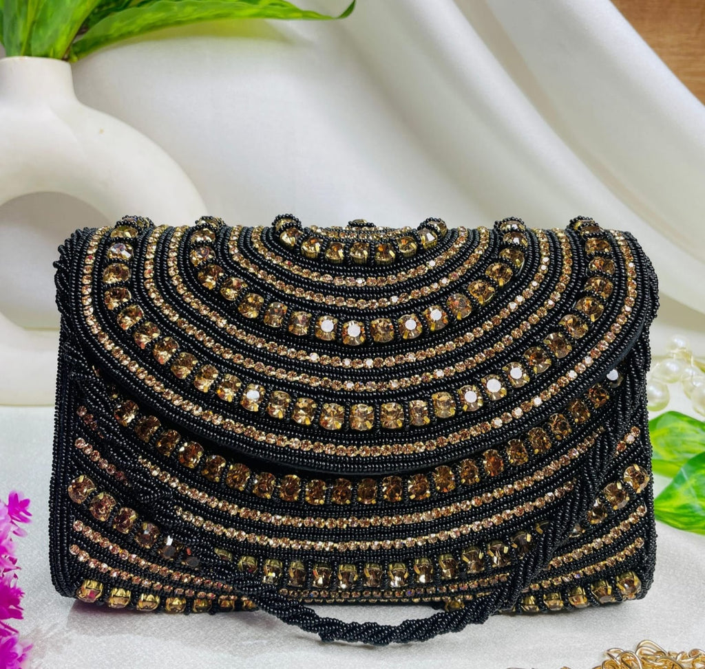 Roshni crystal flap clutch in black and gold with scalloped rows of hand-set stones