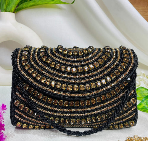 Roshni crystal flap clutch in black and gold with scalloped rows of hand-set stones